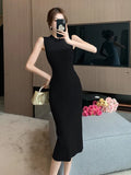 Zingj Woman In A Sleeveless Knitted Dress Is Slim And Slim In